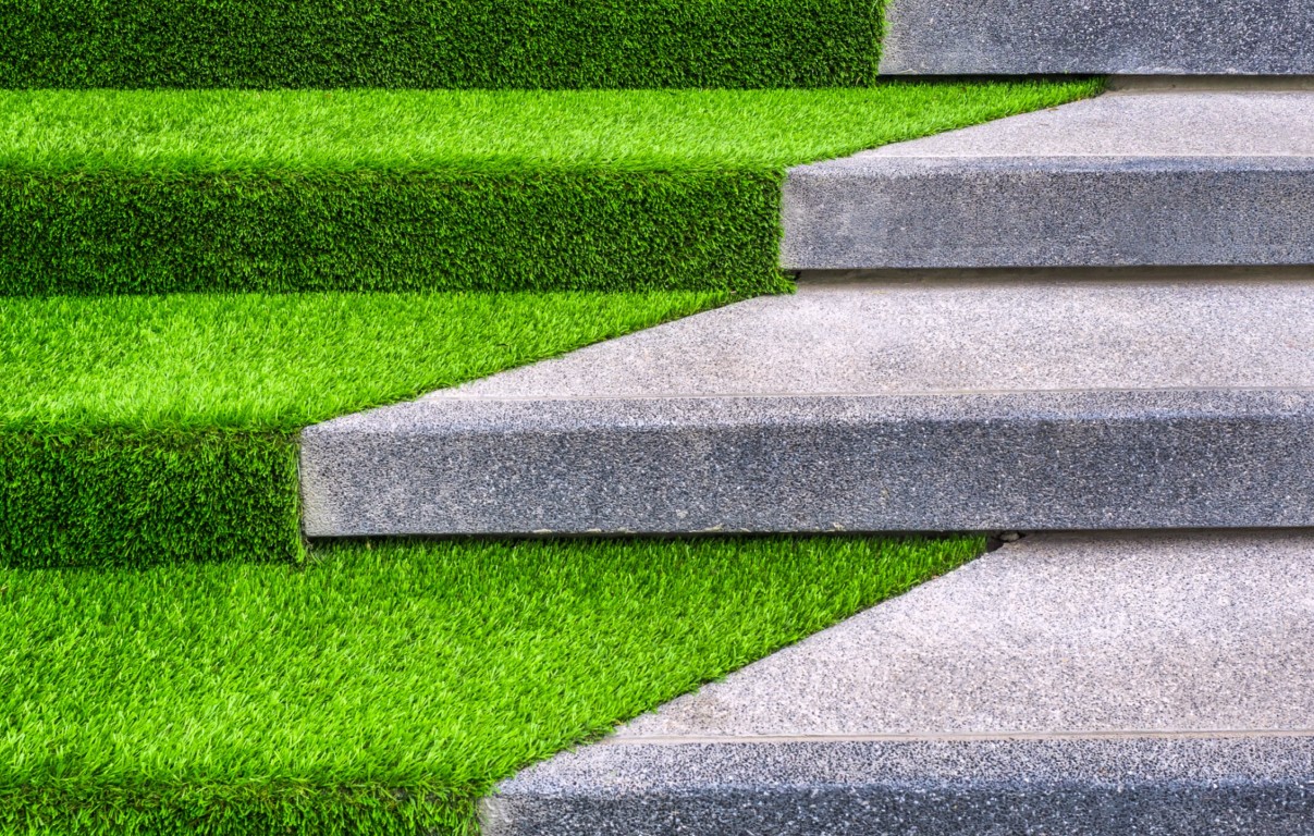 Beautiful mud-free artificial grass installation with stone pavers in Port Arthur, TX